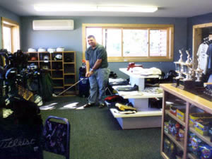 Golfer testing club in proshop 